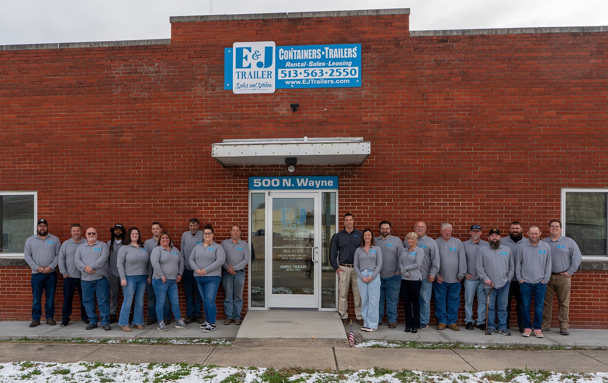 The E&J Trailer team standing together in front of the 500 N. Wayne Cincinnati office, representing our locally owned and family-operated staff.